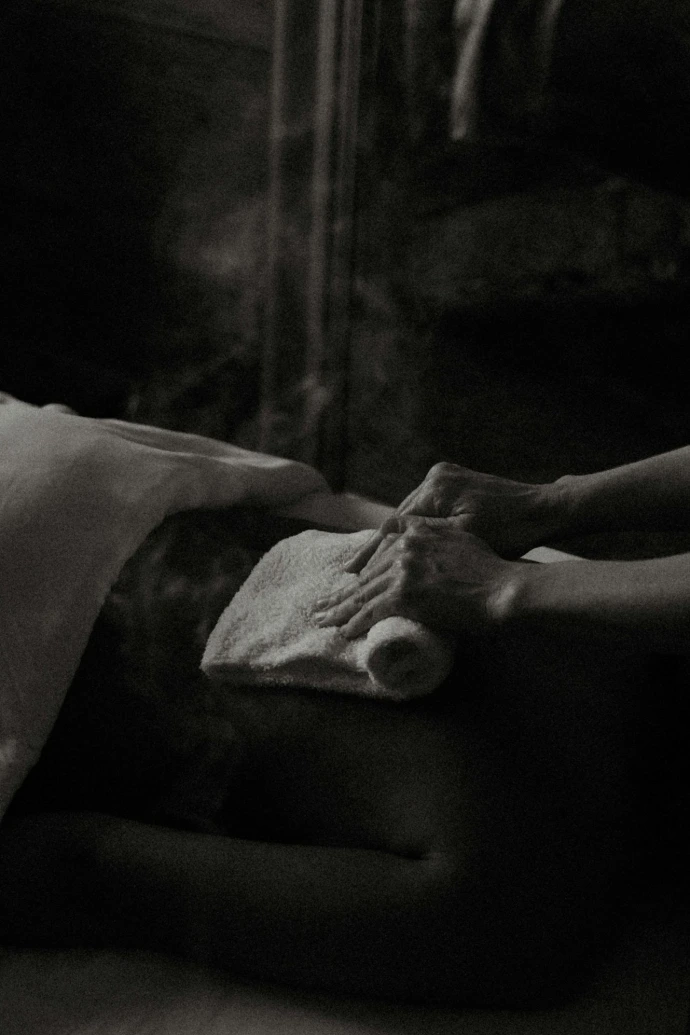 a black and white photo of a person laying in a bed